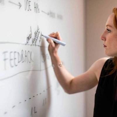 A woman writing about Local SEO on her White Board