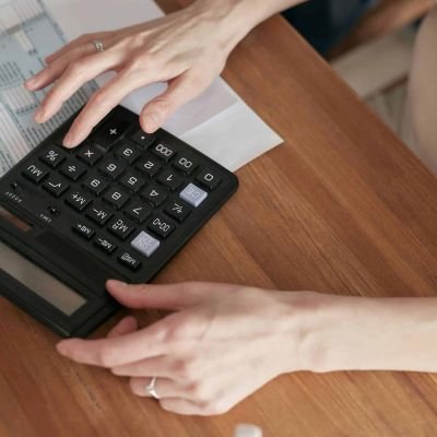 A woman calculating SEO cost on a calculator